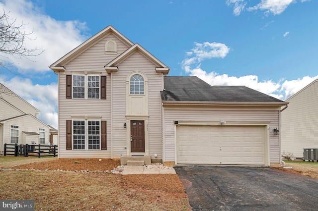 front of property with a garage and central AC unit