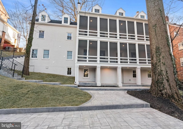 view of property featuring decorative driveway