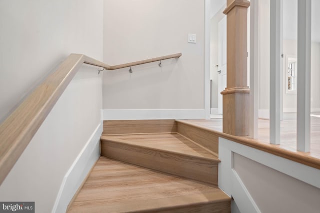 stairway with wood finished floors