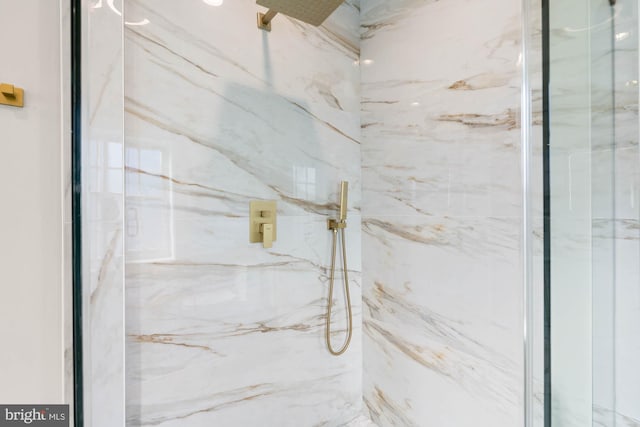 details featuring a marble finish shower