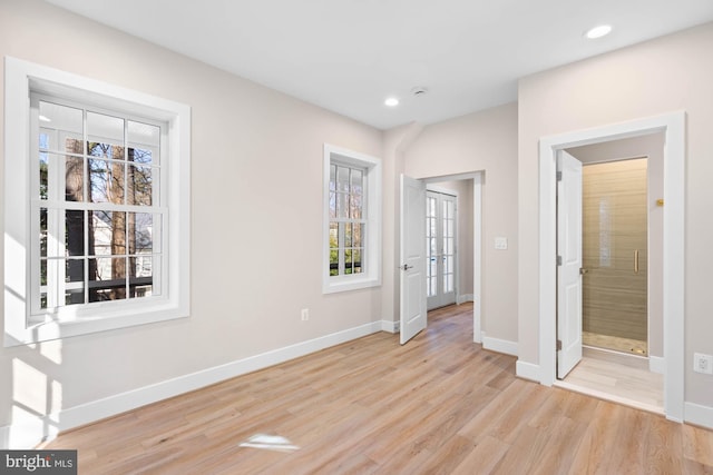 interior space featuring light wood-style floors, baseboards, and recessed lighting