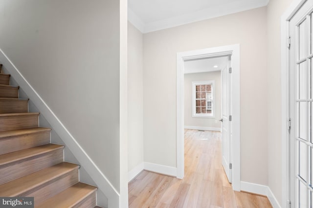 stairway featuring baseboards and wood finished floors