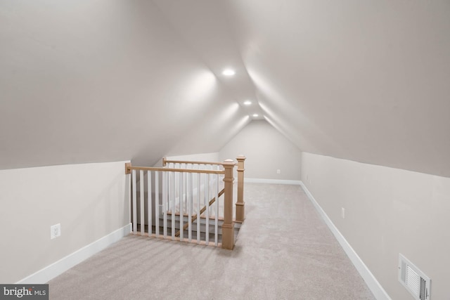 bonus room with vaulted ceiling, carpet floors, visible vents, and baseboards