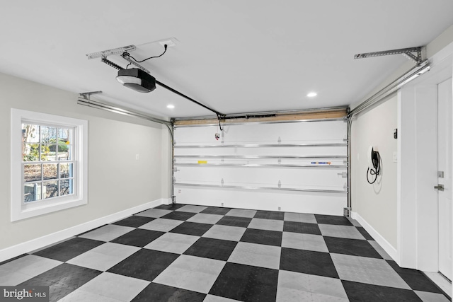 garage with baseboards and a garage door opener