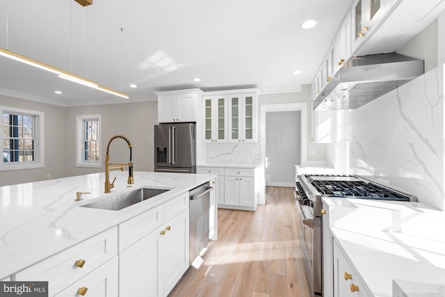 kitchen featuring range hood, glass insert cabinets, white cabinets, a sink, and high quality appliances