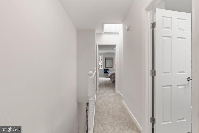 corridor with light colored carpet