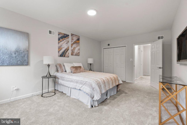 bedroom featuring light carpet and a closet