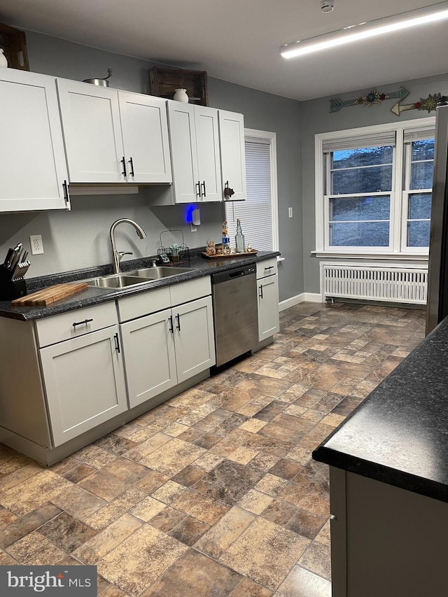 kitchen featuring dishwasher, radiator, sink, and white cabinets