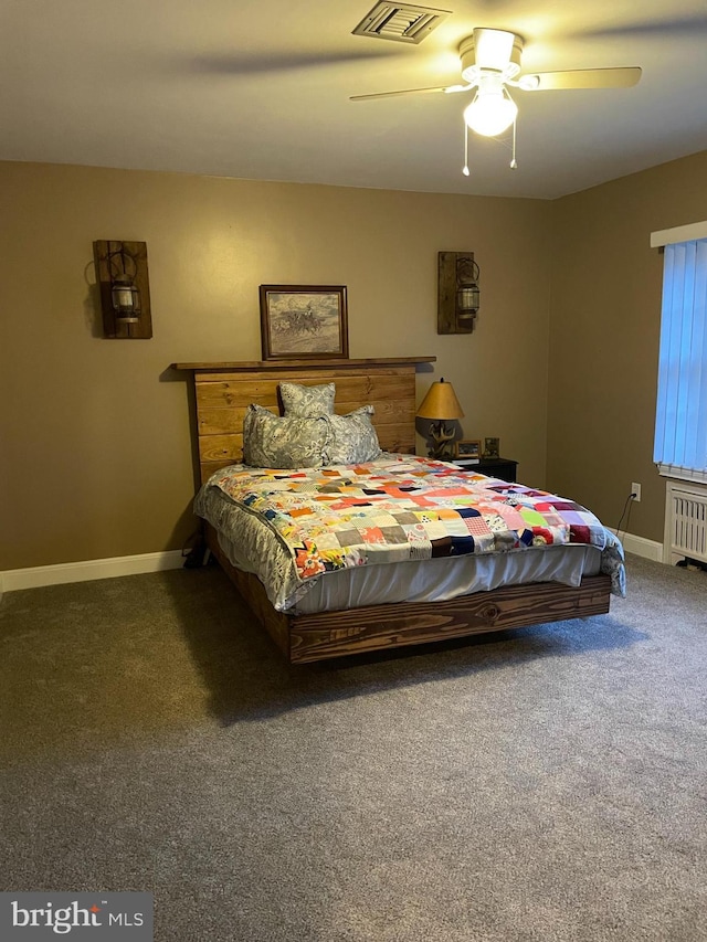 bedroom with radiator, ceiling fan, and dark colored carpet