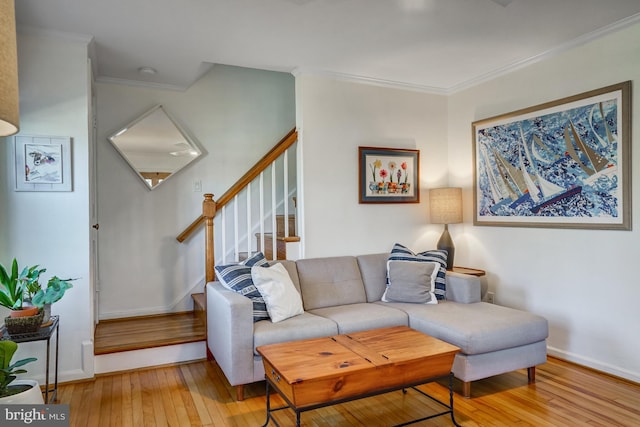 living area featuring ornamental molding, baseboards, stairway, and hardwood / wood-style floors