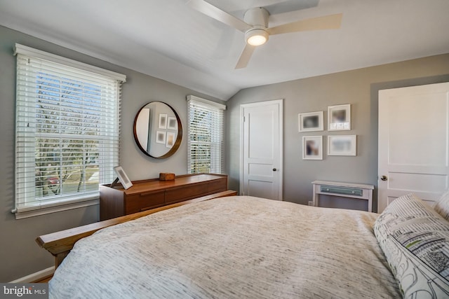 bedroom featuring ceiling fan, lofted ceiling, and baseboards