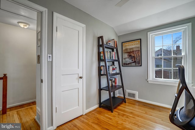 sitting room featuring light wood finished floors, visible vents, and baseboards