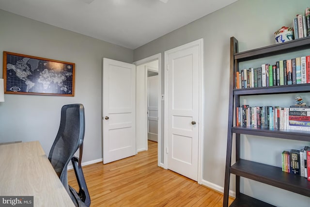 home office featuring wood finished floors and baseboards