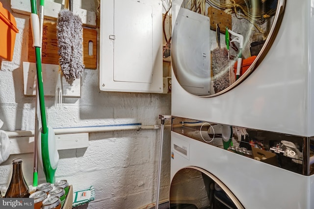 interior space with electric panel and stacked washer / dryer