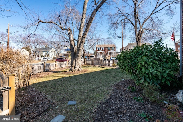 view of yard featuring a fenced backyard and a residential view