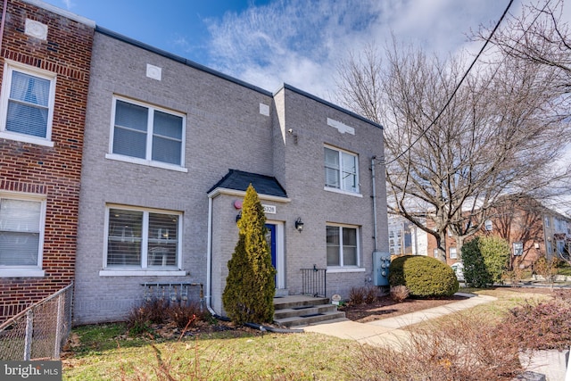 townhome / multi-family property featuring brick siding