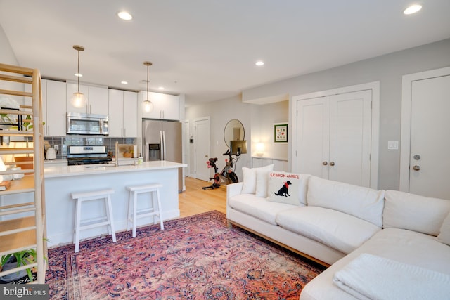 living room featuring light wood-style floors and recessed lighting