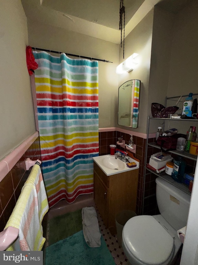 full bathroom featuring tile walls, vanity, toilet, and shower / bathtub combination with curtain