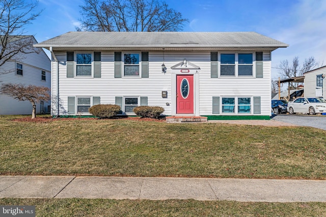 bi-level home with a front lawn