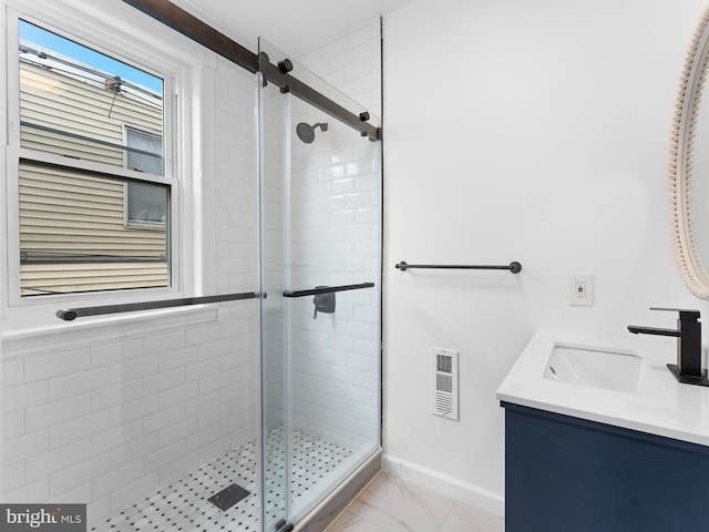 bathroom with vanity and a shower with shower door