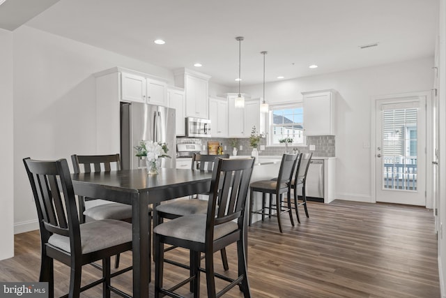 dining area featuring dark wood-type flooring