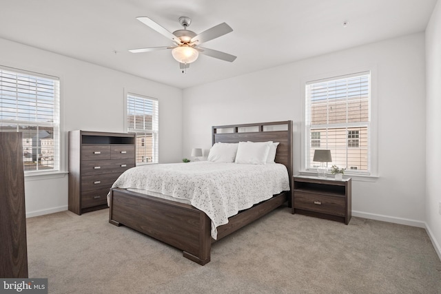 bedroom with ceiling fan and light colored carpet