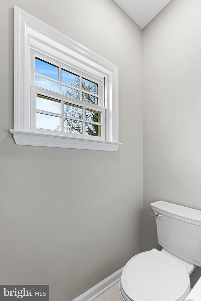 bathroom with toilet and baseboards