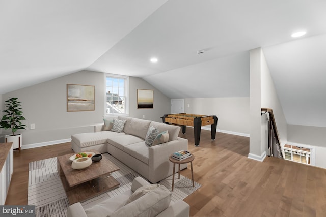 living area with light wood-style floors, baseboards, vaulted ceiling, and recessed lighting