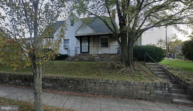 view of front of house with a porch and roof with shingles