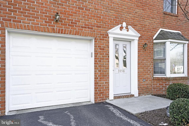 doorway to property with a garage