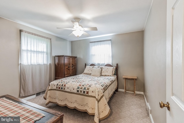 bedroom with ornamental molding, light colored carpet, a ceiling fan, and baseboards