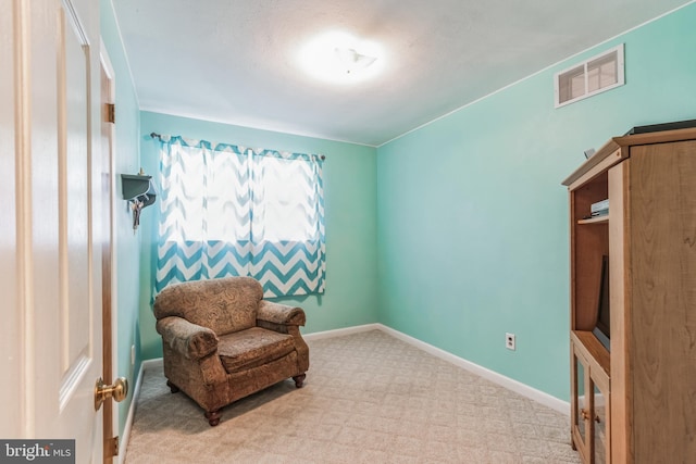 living area featuring light carpet, baseboards, and visible vents