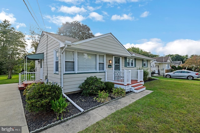 bungalow-style house with a front lawn