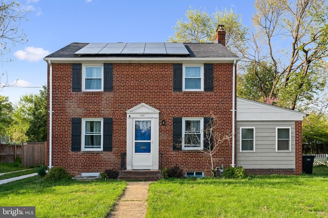 507 Janneys Ln, Alexandria, VA 22302 - view of front facade featuring a chimney, roof mounted solar panels, entry steps, and brick siding