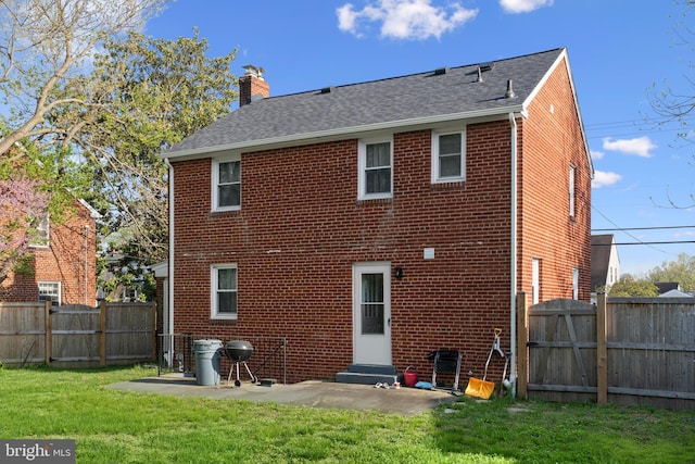 507 Janneys Ln, Alexandria, VA 22302 - back of house with a gate, brick siding, a chimney, roof with shingles, and a patio