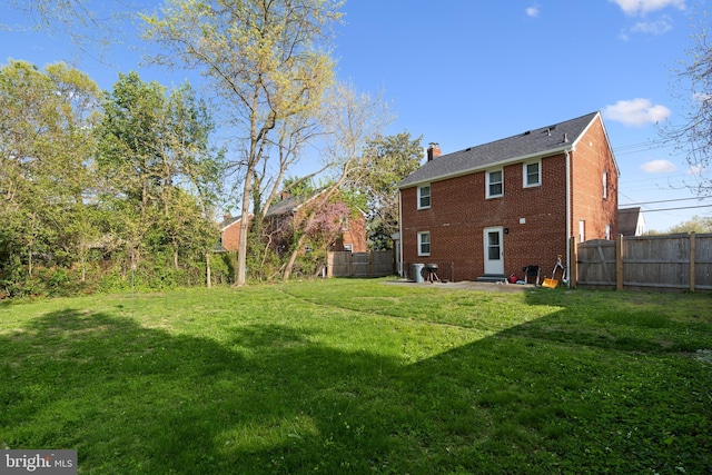 507 Janneys Ln, Alexandria, VA 22302 - rear view of property with brick siding, a chimney, and a patio area