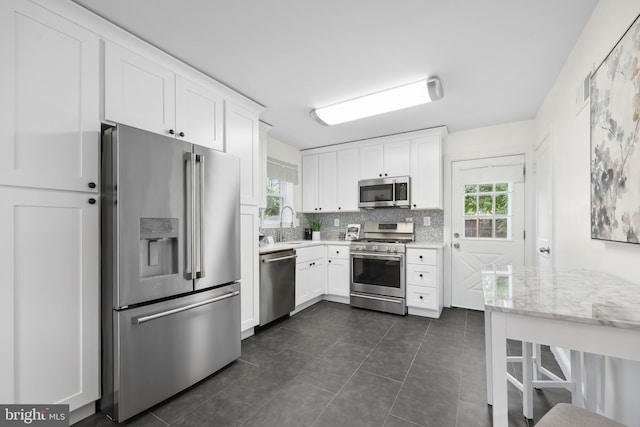 507 Janneys Ln, Alexandria, VA 22302 - kitchen featuring appliances with stainless steel finishes, white cabinetry, and tasteful backsplash