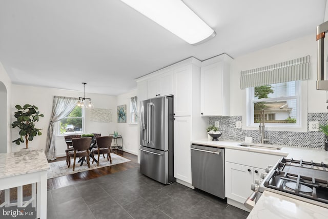 507 Janneys Ln, Alexandria, VA 22302 - kitchen featuring stainless steel appliances, a sink, white cabinetry, and dark tile patterned flooring