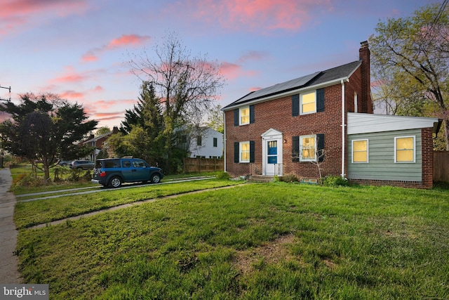 507 Janneys Ln, Alexandria, VA 22302 - view of front of property featuring a chimney, roof mounted solar panels, and brick siding