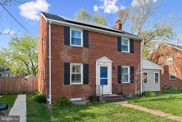 507 Janneys Ln, Alexandria, VA 22302 - view of front of home featuring a chimney, roof mounted solar panels, and brick siding