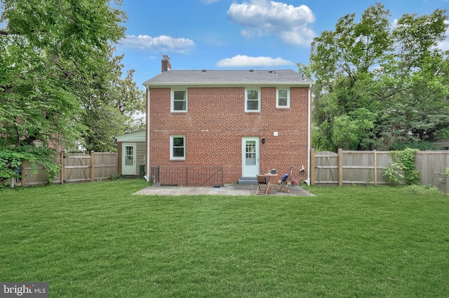 507 Janneys Ln, Alexandria, VA 22302 - back of property featuring a patio area, a chimney, and brick siding