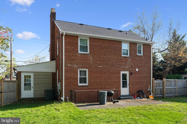 507 Janneys Ln, Alexandria, VA 22302 - back of property featuring a chimney, brick siding, a patio area, central air condition unit, and entry steps