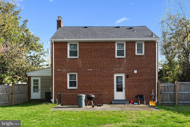 507 Janneys Ln, Alexandria, VA 22302 - rear view of property featuring a chimney, brick siding, a patio, a shingled roof, and central AC unit
