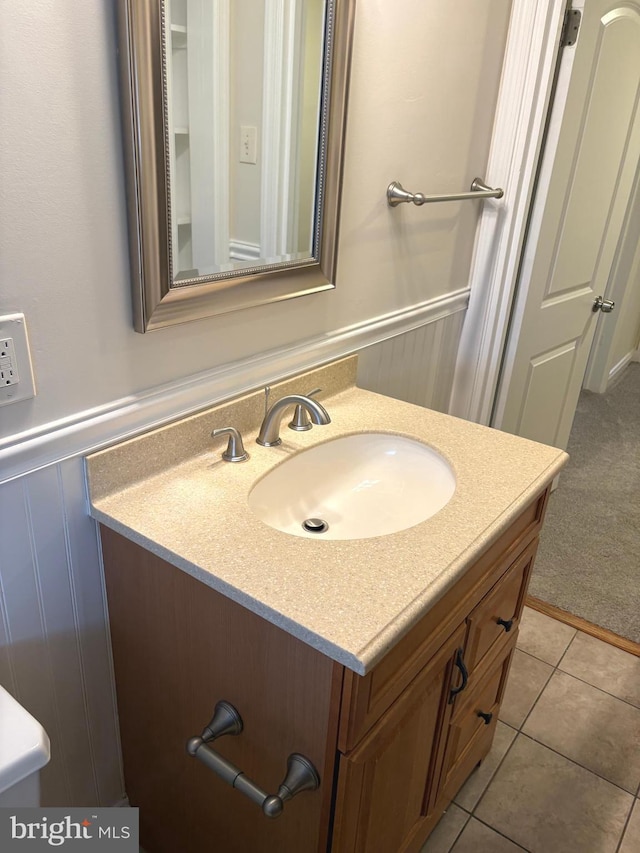 bathroom featuring tile patterned flooring and vanity