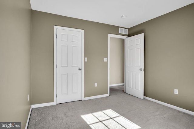 unfurnished bedroom featuring light colored carpet