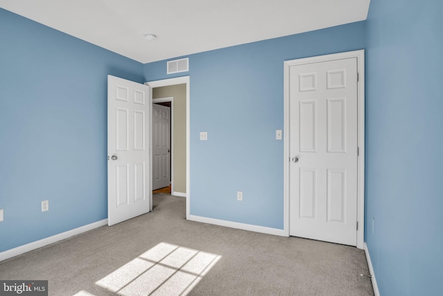 unfurnished bedroom featuring light colored carpet