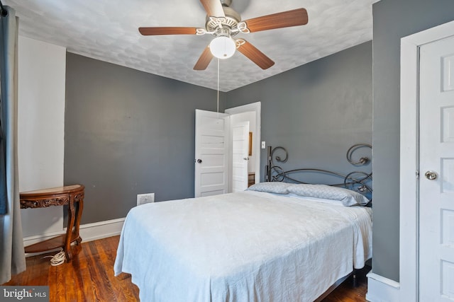 bedroom featuring dark wood-type flooring and ceiling fan