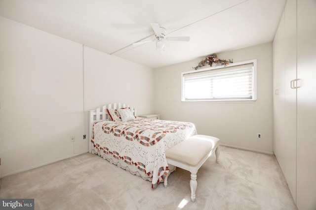 bedroom featuring ceiling fan and light colored carpet