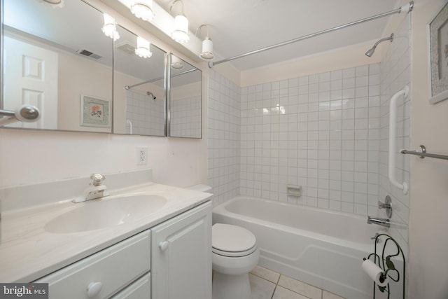 full bathroom featuring tiled shower / bath, vanity, toilet, and tile patterned flooring