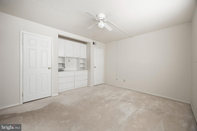 unfurnished bedroom featuring light colored carpet and ceiling fan